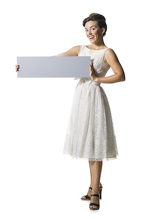 simsearch:640-01355807,k - Woman in white dress holding a blank sign Foto de stock - Sin royalties Premium, Código: 640-02769858