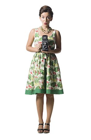 simsearch:640-01355807,k - Woman in floral dress holding antique camera Foto de stock - Sin royalties Premium, Código: 640-02769850