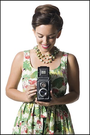simsearch:640-01355807,k - Woman in floral dress holding antique camera Stock Photo - Premium Royalty-Free, Code: 640-02769851