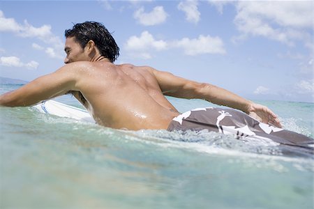 simsearch:640-02773714,k - Man lying on surfboard in water Fotografie stock - Premium Royalty-Free, Codice: 640-02774121