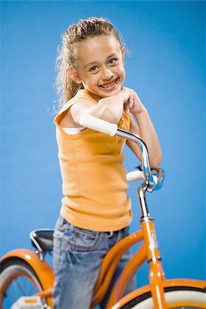 simsearch:640-02765240,k - Girl on orange bicycle smiling Foto de stock - Sin royalties Premium, Código: 640-02774416