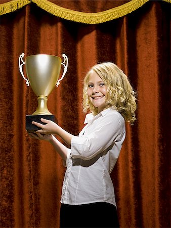 simsearch:640-01575004,k - Girl holding trophy cup smiling Foto de stock - Sin royalties Premium, Código: 640-02774444