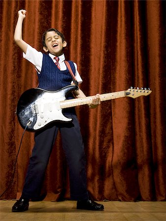 simsearch:640-02774467,k - Boy on stage playing electric guitar Stock Photo - Premium Royalty-Free, Code: 640-02774488