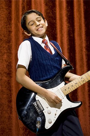 simsearch:640-02774467,k - Boy on stage playing electric guitar Stock Photo - Premium Royalty-Free, Code: 640-02774483