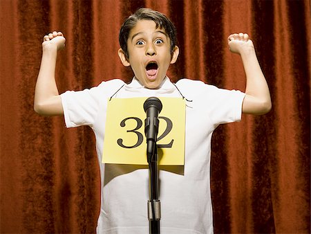 simsearch:640-02774365,k - Boy contestant standing at microphone cheering Stock Photo - Premium Royalty-Free, Code: 640-02774505