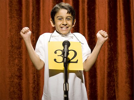 simsearch:640-02774365,k - Boy contestant standing at microphone cheering Stock Photo - Premium Royalty-Free, Code: 640-02774506