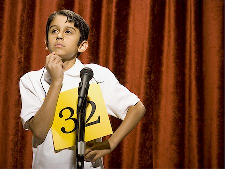 simsearch:640-02774365,k - Boy contestant standing at microphone thinking Stock Photo - Premium Royalty-Free, Code: 640-02774507
