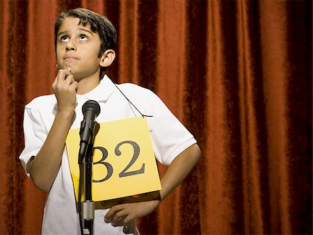 simsearch:640-02774365,k - Boy contestant standing at microphone thinking Stock Photo - Premium Royalty-Free, Code: 640-02774509
