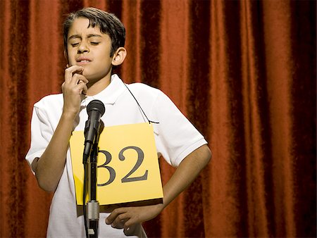 simsearch:640-02774365,k - Boy contestant standing at microphone thinking Stock Photo - Premium Royalty-Free, Code: 640-02774510