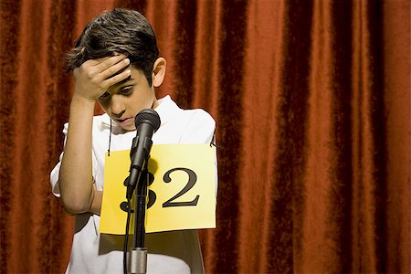 simsearch:640-02774365,k - Boy contestant standing at microphone thinking Stock Photo - Premium Royalty-Free, Code: 640-02774511