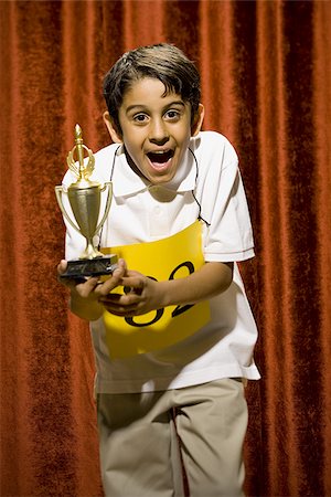 simsearch:640-02774365,k - Boy contestant holding trophy Stock Photo - Premium Royalty-Free, Code: 640-02774536