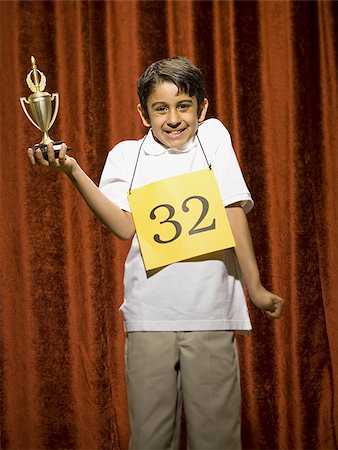 simsearch:640-02774365,k - Boy contestant holding trophy Stock Photo - Premium Royalty-Free, Code: 640-02774539