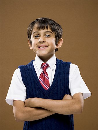 simsearch:640-02774365,k - Boy standing with arms crossed smiling Stock Photo - Premium Royalty-Free, Code: 640-02774597