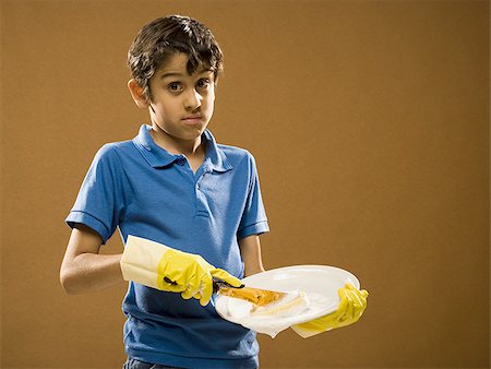 simsearch:640-02774365,k - Boy with rubber gloves scrubbing plate Stock Photo - Premium Royalty-Free, Code: 640-02774644