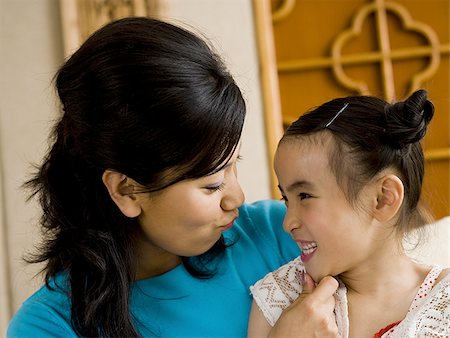 simsearch:640-01601434,k - Mother giving daughter a kiss on cheek Stock Photo - Premium Royalty-Free, Code: 640-02775110