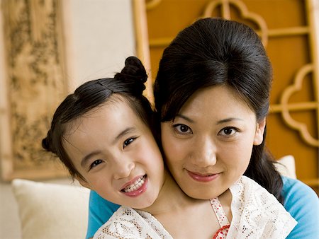 simsearch:640-01601434,k - Mother giving daughter a kiss on cheek Stock Photo - Premium Royalty-Free, Code: 640-02775111