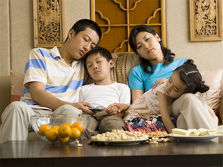 sleeping in female partner hug pic - Family asleep on couch Stock Photo - Premium Royalty-Free, Code: 640-02775135