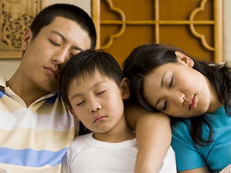 sleeping in female partner hug pic - Family asleep on couch Stock Photo - Premium Royalty-Free, Code: 640-02775136