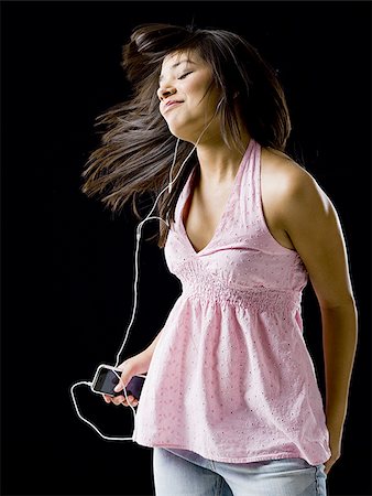 Femme avec lecteur mp3 danse et souriant Photographie de stock - Premium Libres de Droits, Code: 640-02775220
