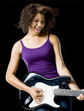smile teeth braces - Girl playing electric guitar Stock Photo - Premium Royalty-Free, Code: 640-02775276