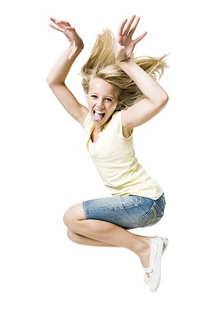 Girl smiling and leaping with hand up Stock Photo - Premium Royalty-Free, Code: 640-02775318