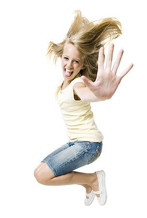 Girl smiling and leaping with hand up Stock Photo - Premium Royalty-Free, Code: 640-02775319