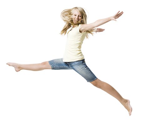 Girl leaping and smiling with arms up Stock Photo - Premium Royalty-Free, Code: 640-02775311