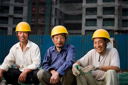 Three male construction workers with helmets outdoors smiling Stock Photo - Premium Royalty-Free, Code: 640-02775457