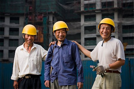Three male construction workers with helmets outdoors smiling Stock Photo - Premium Royalty-Free, Code: 640-02775458