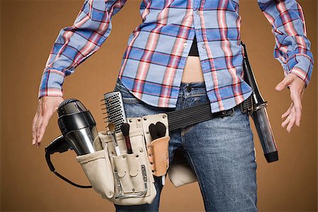 Mid section view of hairdresser with tool belt Foto de stock - Royalty Free Premium, Número: 640-02775940