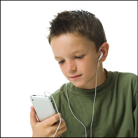 Boy listening to MP3 player. Stock Photo - Premium Royalty-Free, Code: 640-02775977