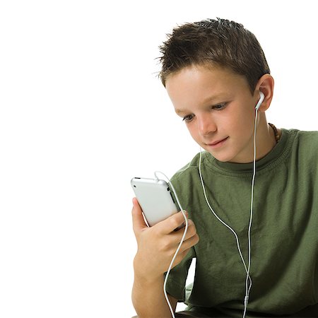 Boy listening to MP3 player. Stock Photo - Premium Royalty-Free, Code: 640-02775978