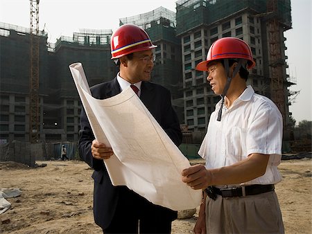 Architect on the job site with a worker. Stock Photo - Premium Royalty-Free, Code: 640-02776041