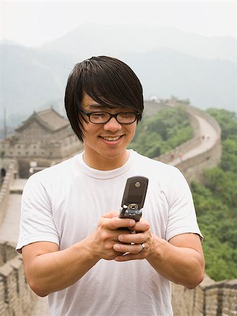 simsearch:640-02776034,k - Junger Mann an der chinesischen Mauer auf einem Mobiltelefon. Stockbilder - Premium RF Lizenzfrei, Bildnummer: 640-02776074