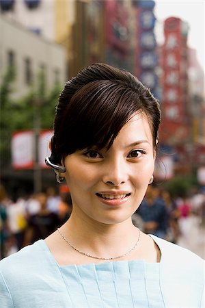 simsearch:640-02949618,k - Woman with a cell phone earpiece. Stock Photo - Premium Royalty-Free, Code: 640-02776158
