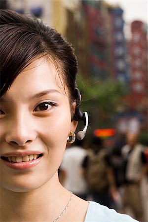 simsearch:640-02949618,k - Woman with a cell phone earpiece. Stock Photo - Premium Royalty-Free, Code: 640-02776164