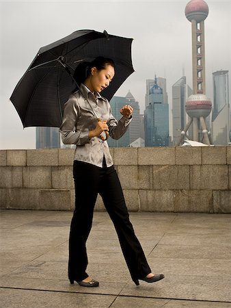 Young woman under an umbrella. Stock Photo - Premium Royalty-Free, Code: 640-02776222