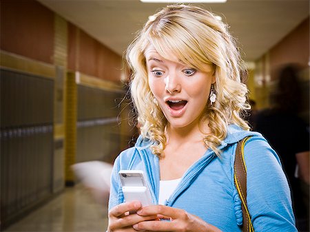 High School girl at school text messaging. Stock Photo - Premium Royalty-Free, Code: 640-02776402