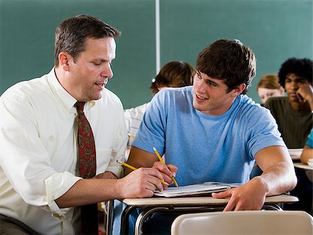 Student and teacher in a classroom. Stock Photo - Premium Royalty-Free, Code: 640-02776531