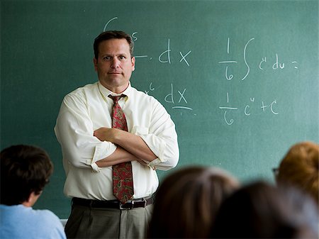 student portrait teacher not smiling - Teacher in a classroom. Stock Photo - Premium Royalty-Free, Code: 640-02776569