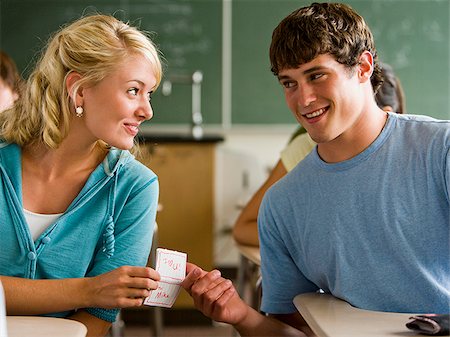 students flirting in classroom - Students passing notes in a classroom. Stock Photo - Premium Royalty-Free, Code: 640-02776589