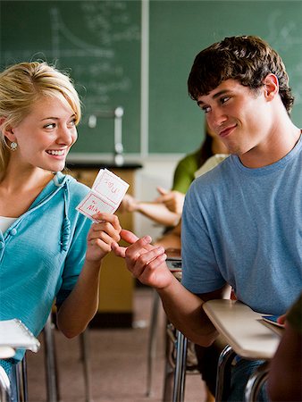 female teenagers students in a class - Students passing notes in a classroom. Stock Photo - Premium Royalty-Free, Code: 640-02776591