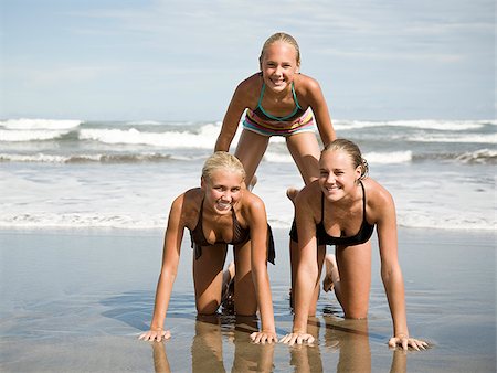 swim wear - Human pyramid on the beach. Stock Photo - Premium Royalty-Free, Code: 640-02776600