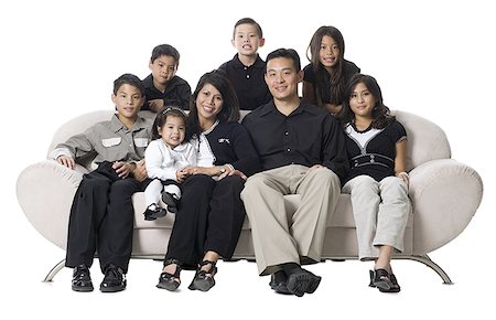 simsearch:640-02776733,k - Family sitting on a couch smiling. Foto de stock - Sin royalties Premium, Código: 640-02776721