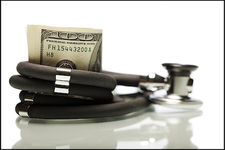 Money wrapped in a stethoscope. Stock Photo - Premium Royalty-Free, Code: 640-02776936