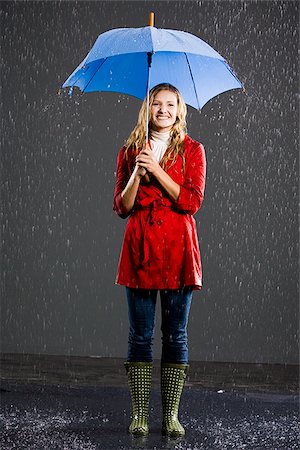 person and raincoat and umbrella - Young woman with an umbrella. Stock Photo - Premium Royalty-Free, Code: 640-02777174