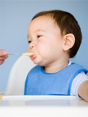 baby boy with a blue bib. Stock Photo - Premium Royalty-Free, Code: 640-02777276