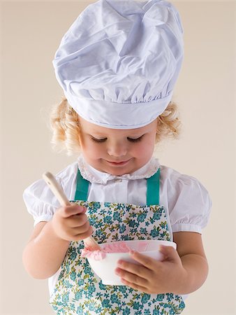 little girl with a chef's hat on. Stock Photo - Premium Royalty-Free, Code: 640-02777376