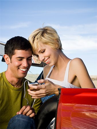 man and woman next to a red convertible Stock Photo - Premium Royalty-Free, Code: 640-02777584