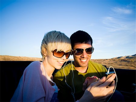 man and woman next to a red convertible Stock Photo - Premium Royalty-Free, Code: 640-02777641